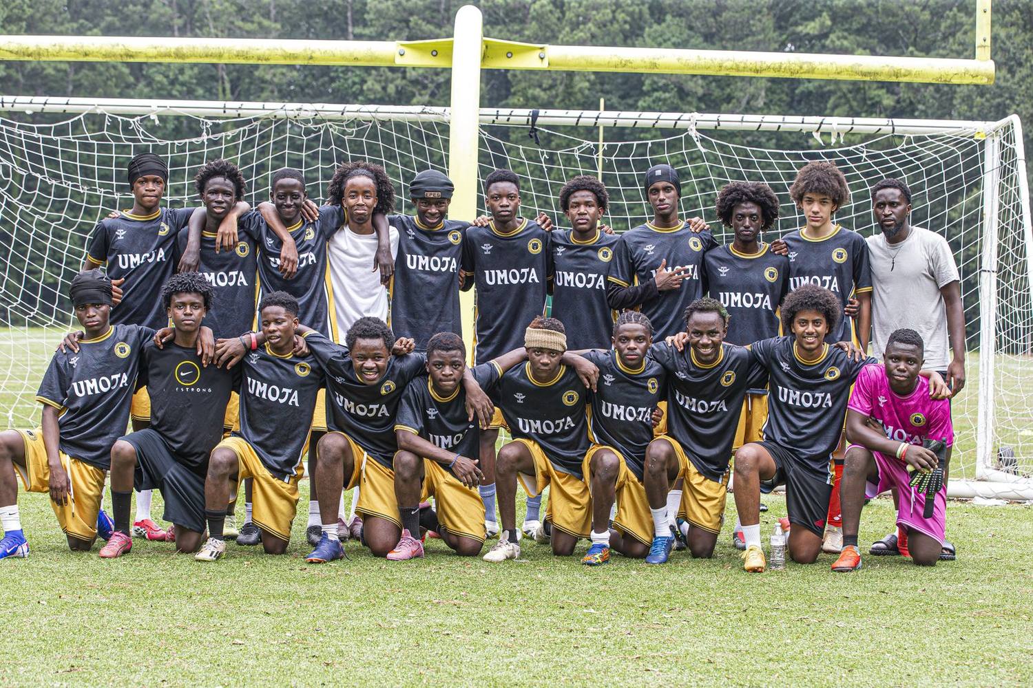 Umoja U18/19 squad together on the field